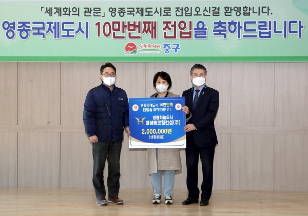 인천시 중구 홍인성 청장이 주민에게 영종도 인구 10만명 돌파 축하를 하고 있다.